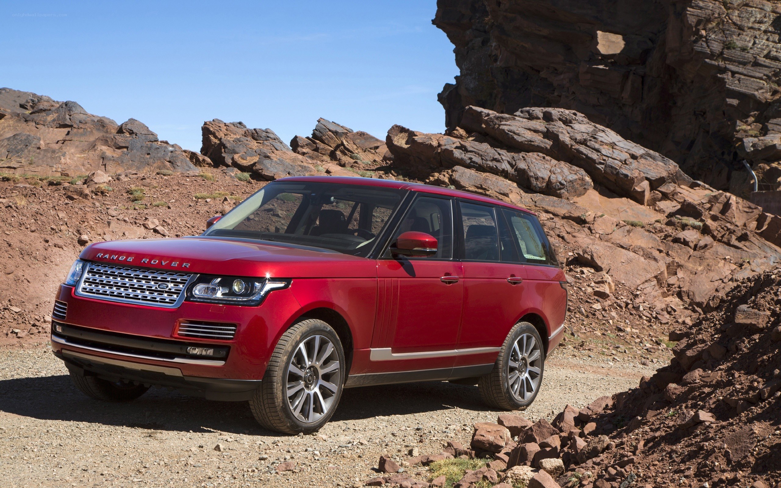 Red Range Rover in rocky terrain