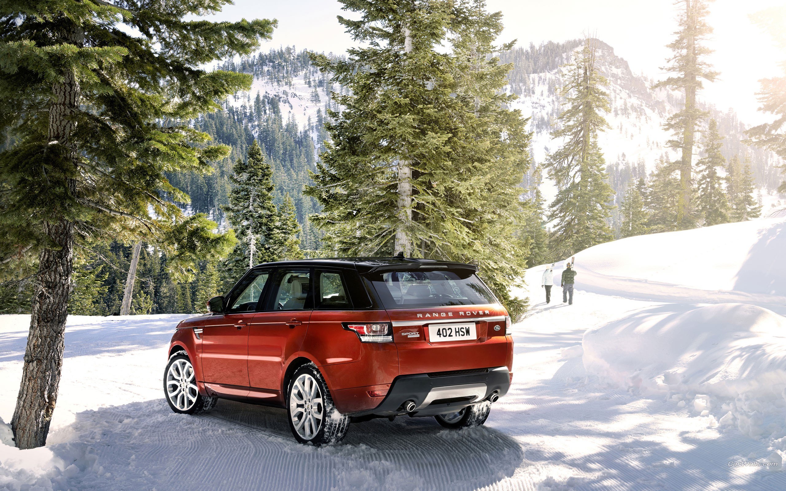 Red Range Rover in snowy forest