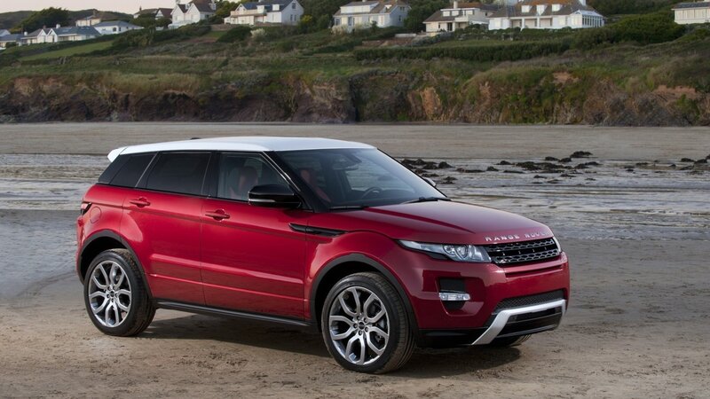 Red Range Rover on a beach