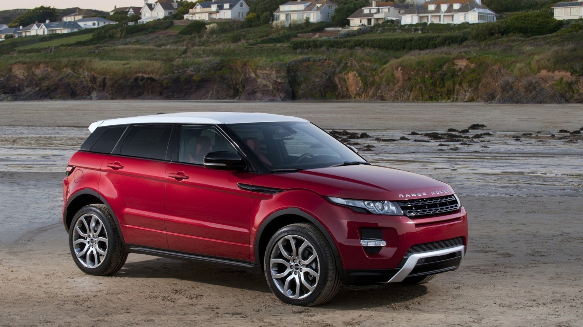 Red Range Rover on a beach
