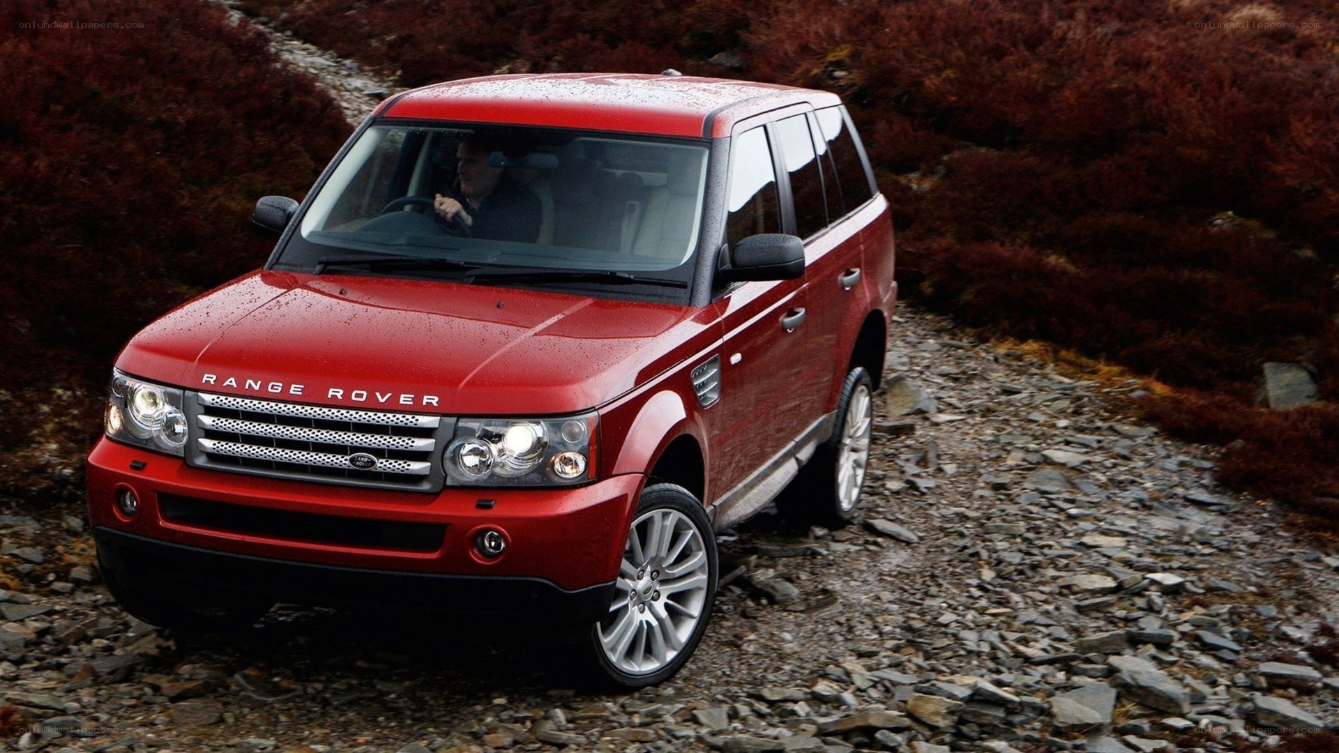 Red Range Rover on a rocky path