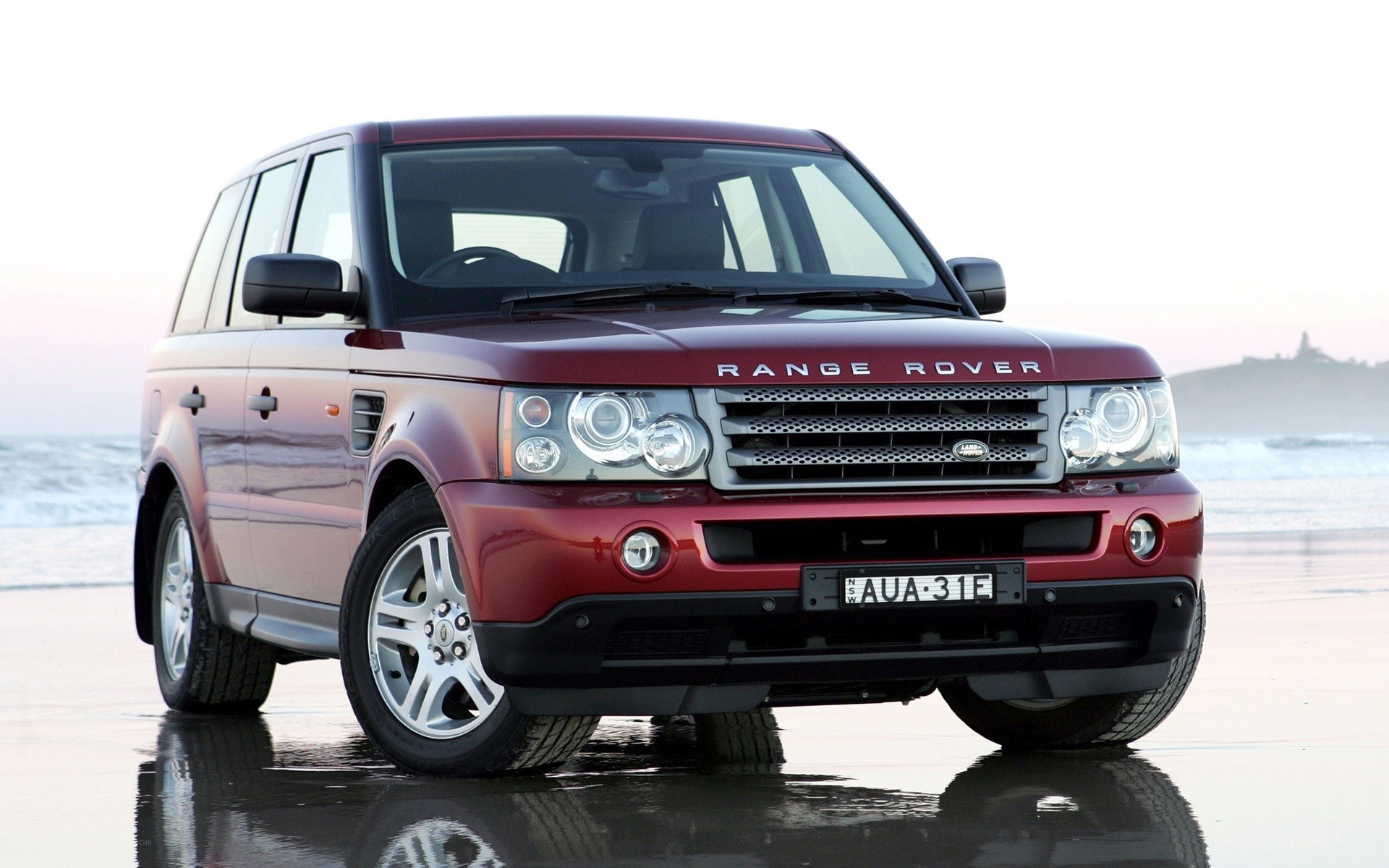 Red Range Rover on beach