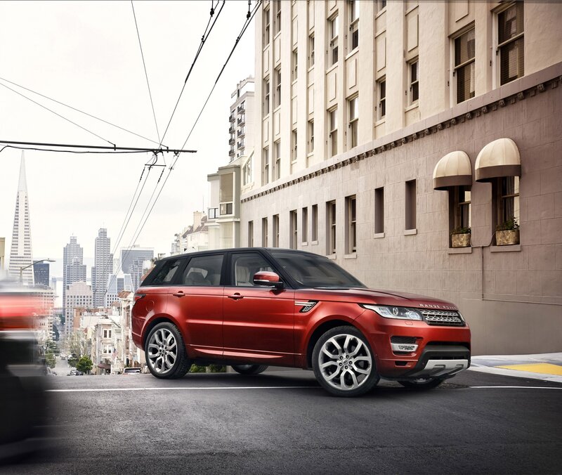 Red Range Rover on city street