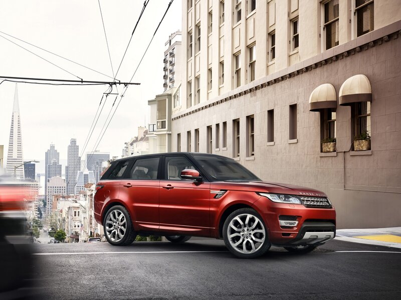 Red Range Rover on city street