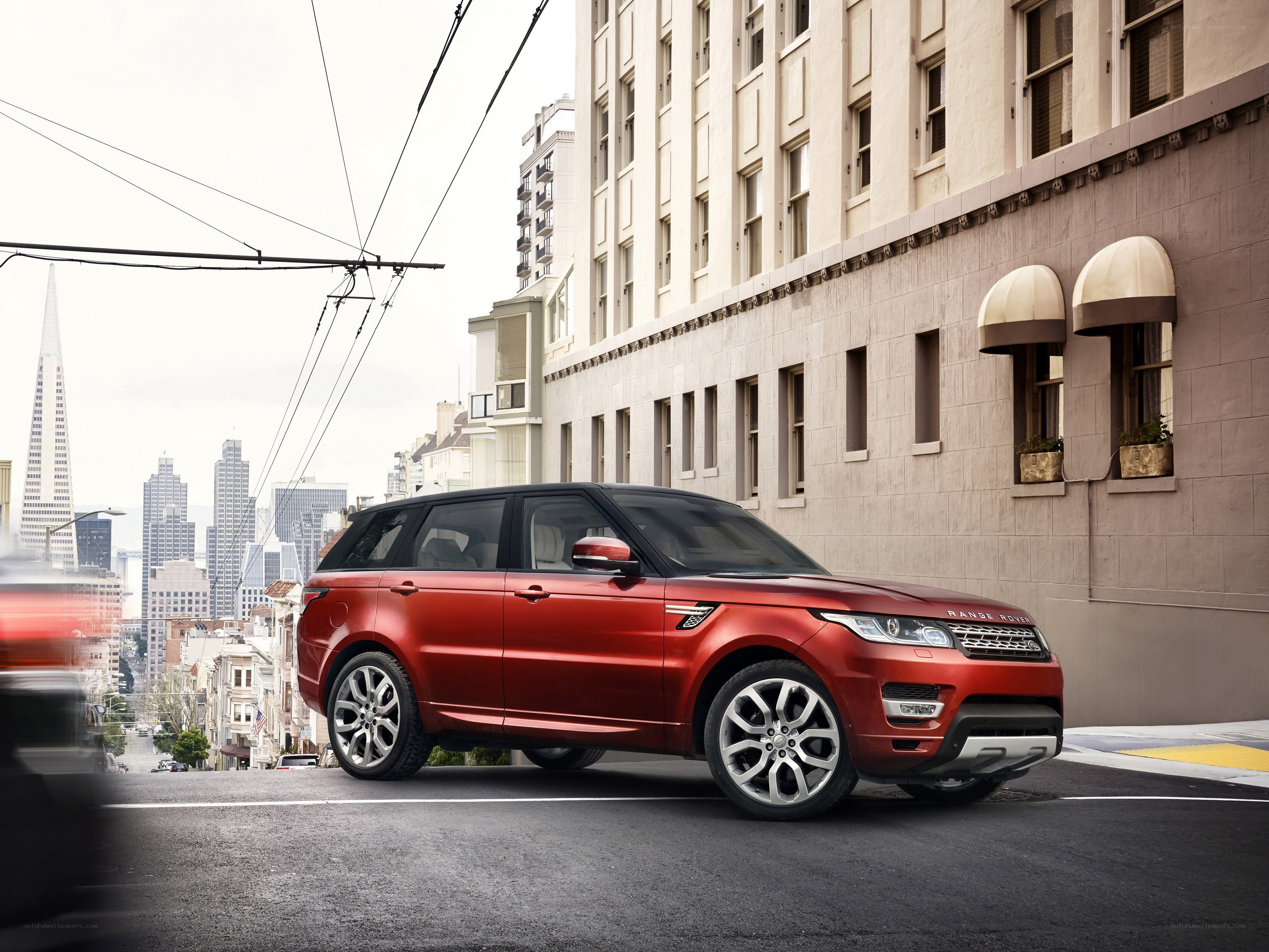 Red Range Rover on city street