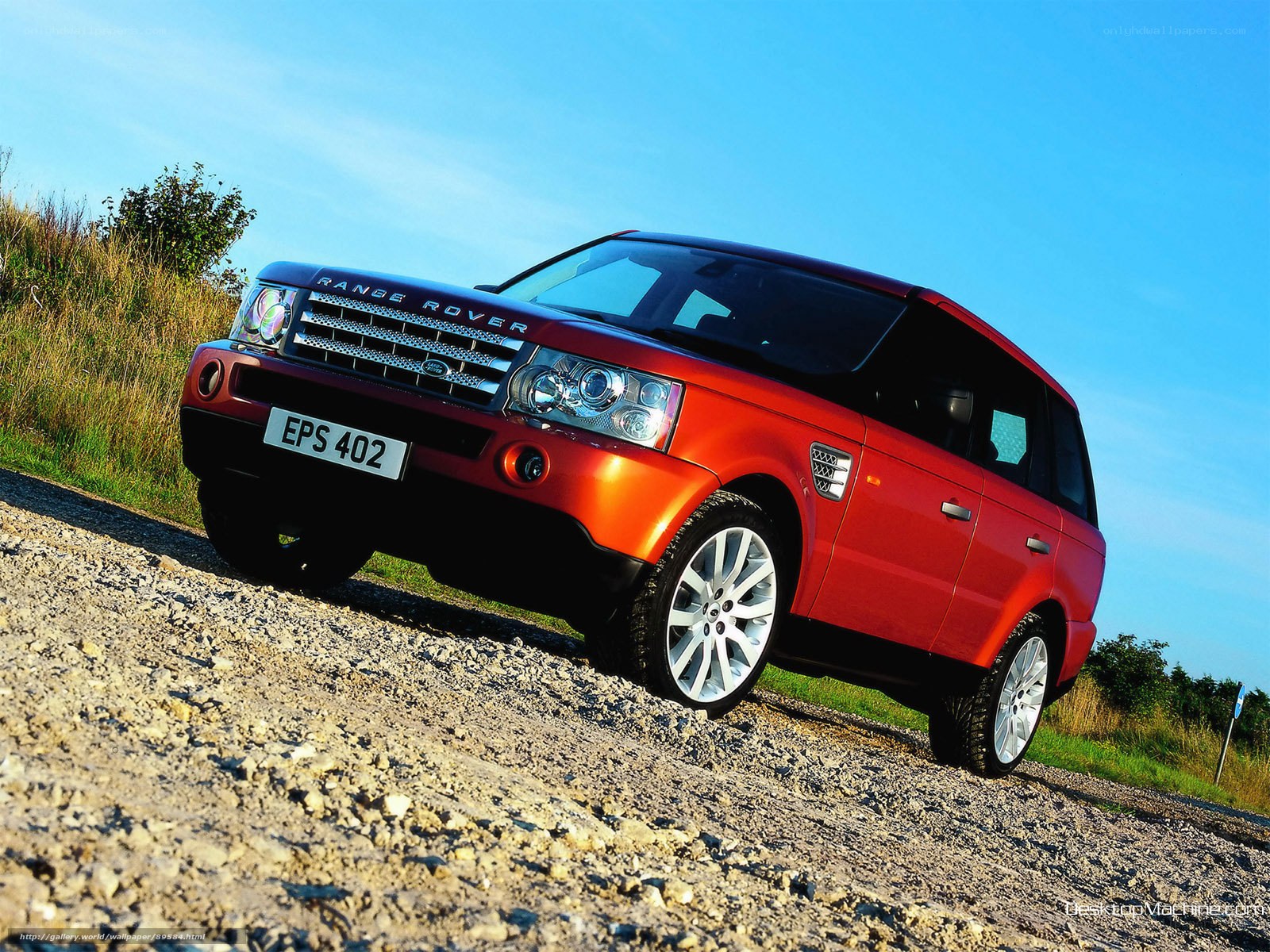 Red Range Rover on gravel road