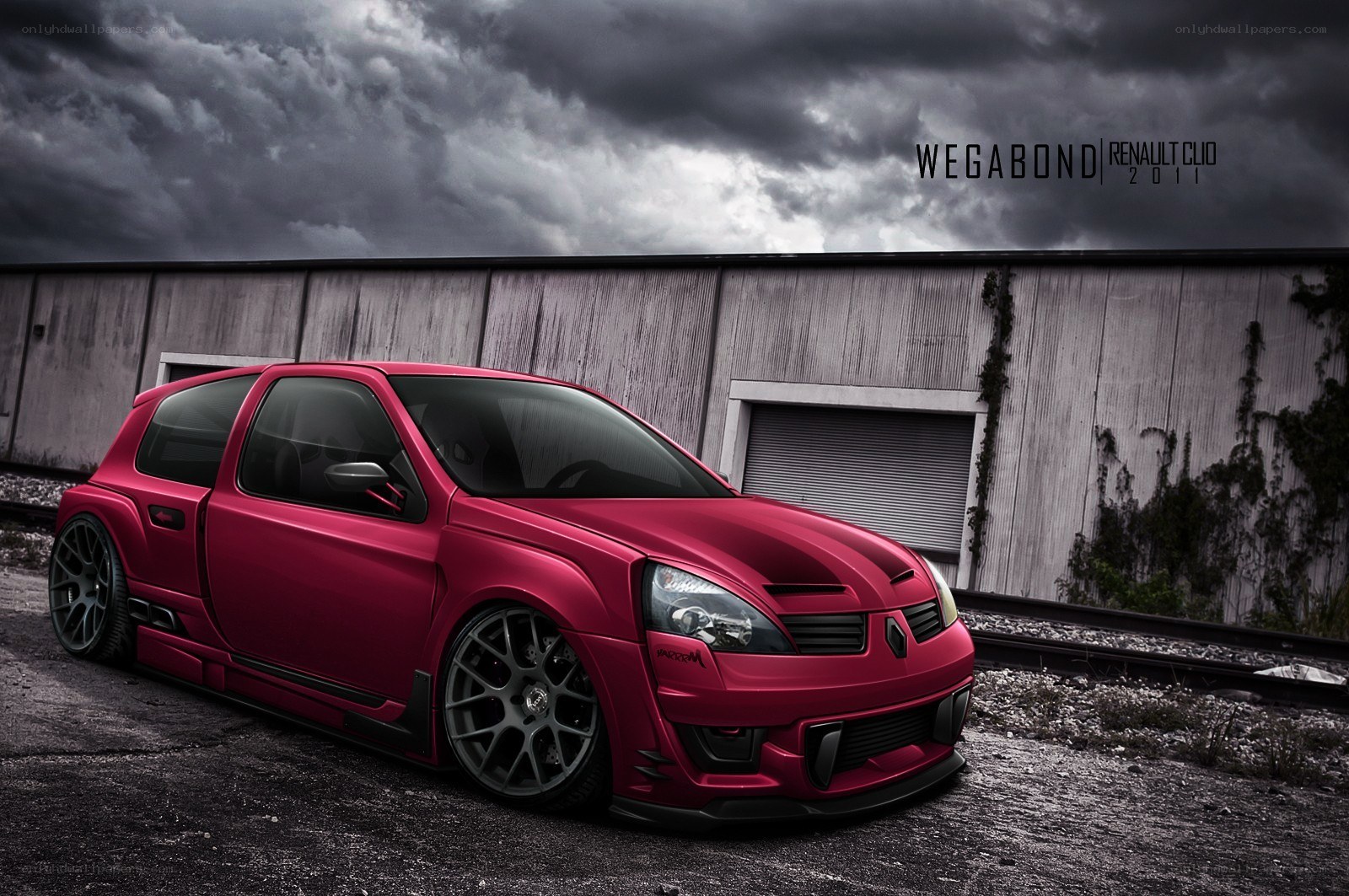 Red Renault Clio in industrial setting