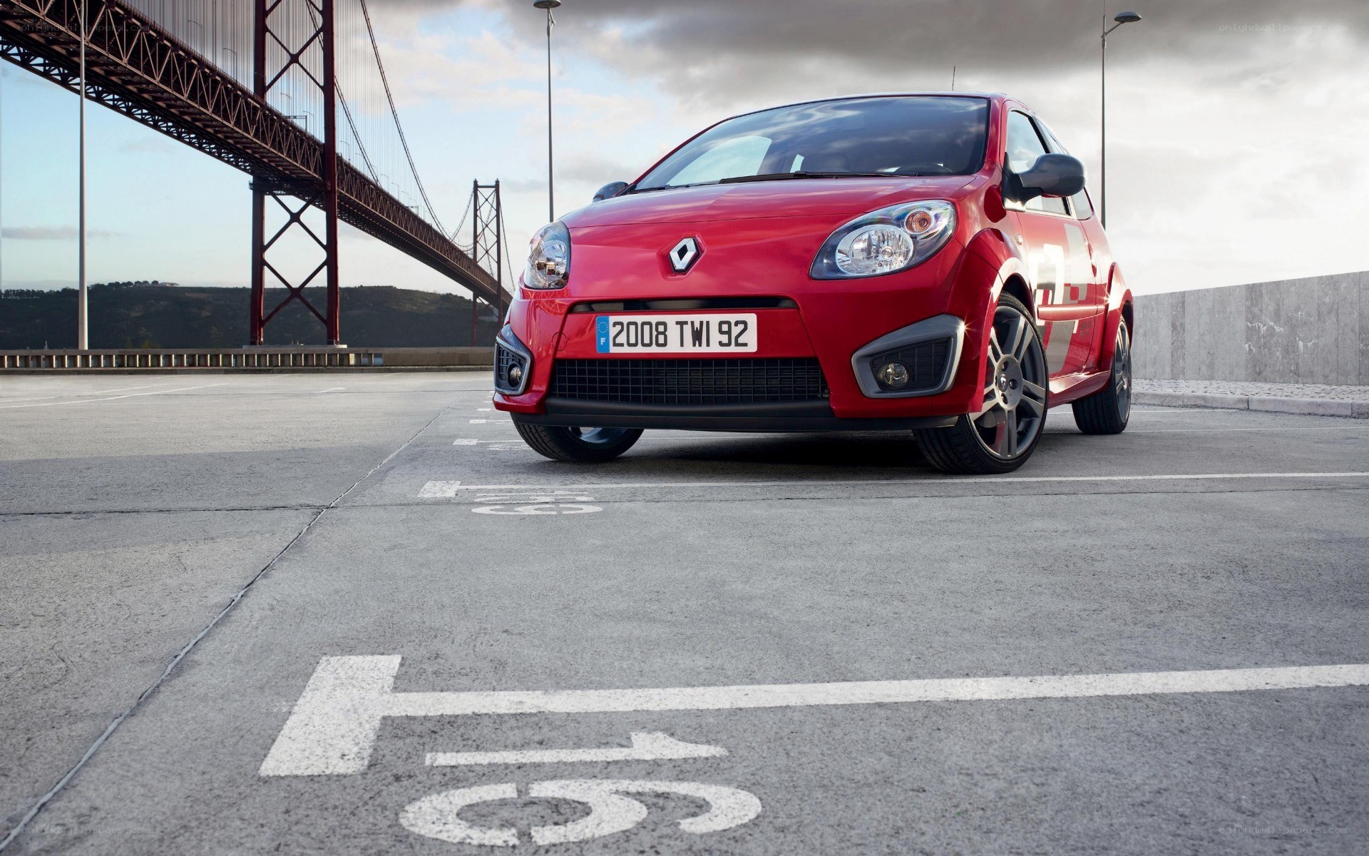 Red Renault Clio parked by bridge