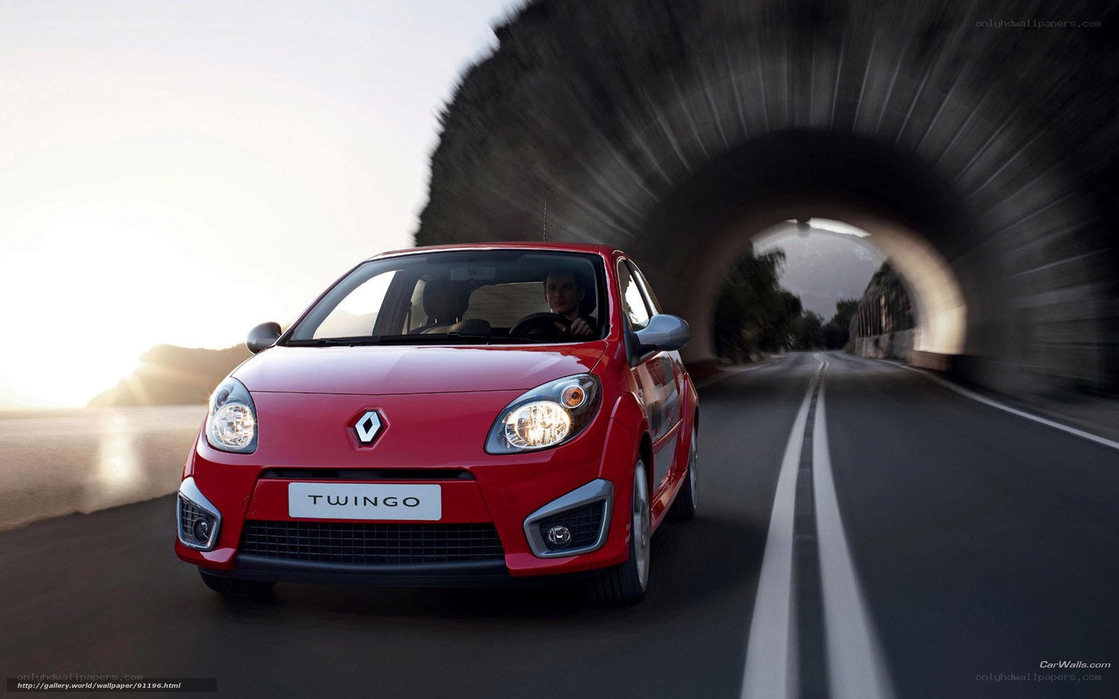 Red Renault Twingo driving through tunnel