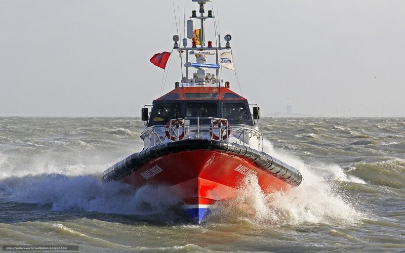 Red rescue boat in rough sea