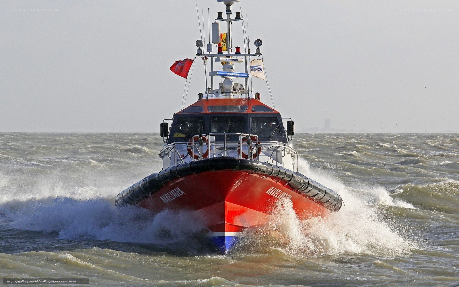 Red rescue boat in rough sea