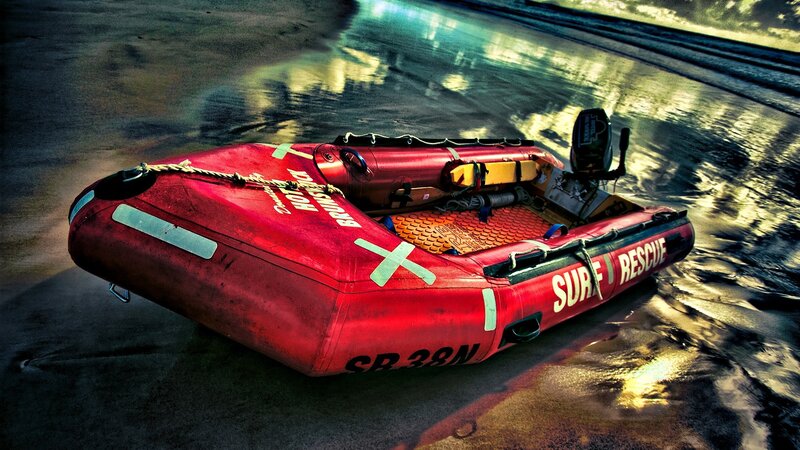 Red rescue boat on beach