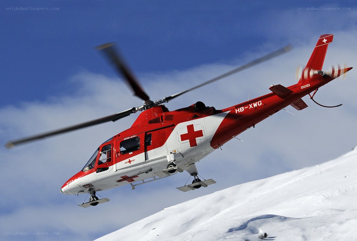 Red rescue helicopter in flight