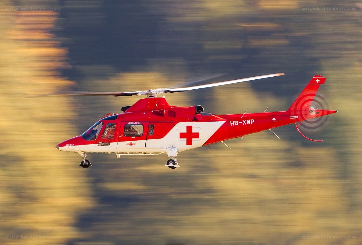 Red rescue helicopter in flight