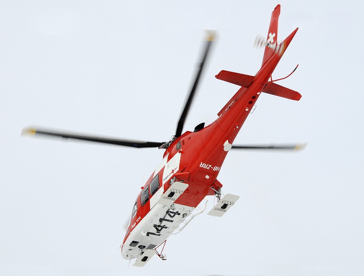 Red rescue helicopter in flight