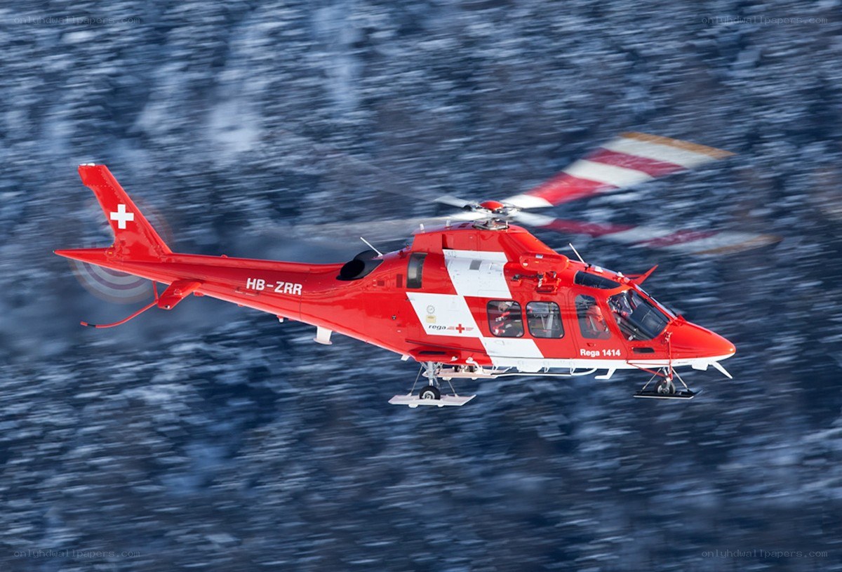 Red rescue helicopter in flight
