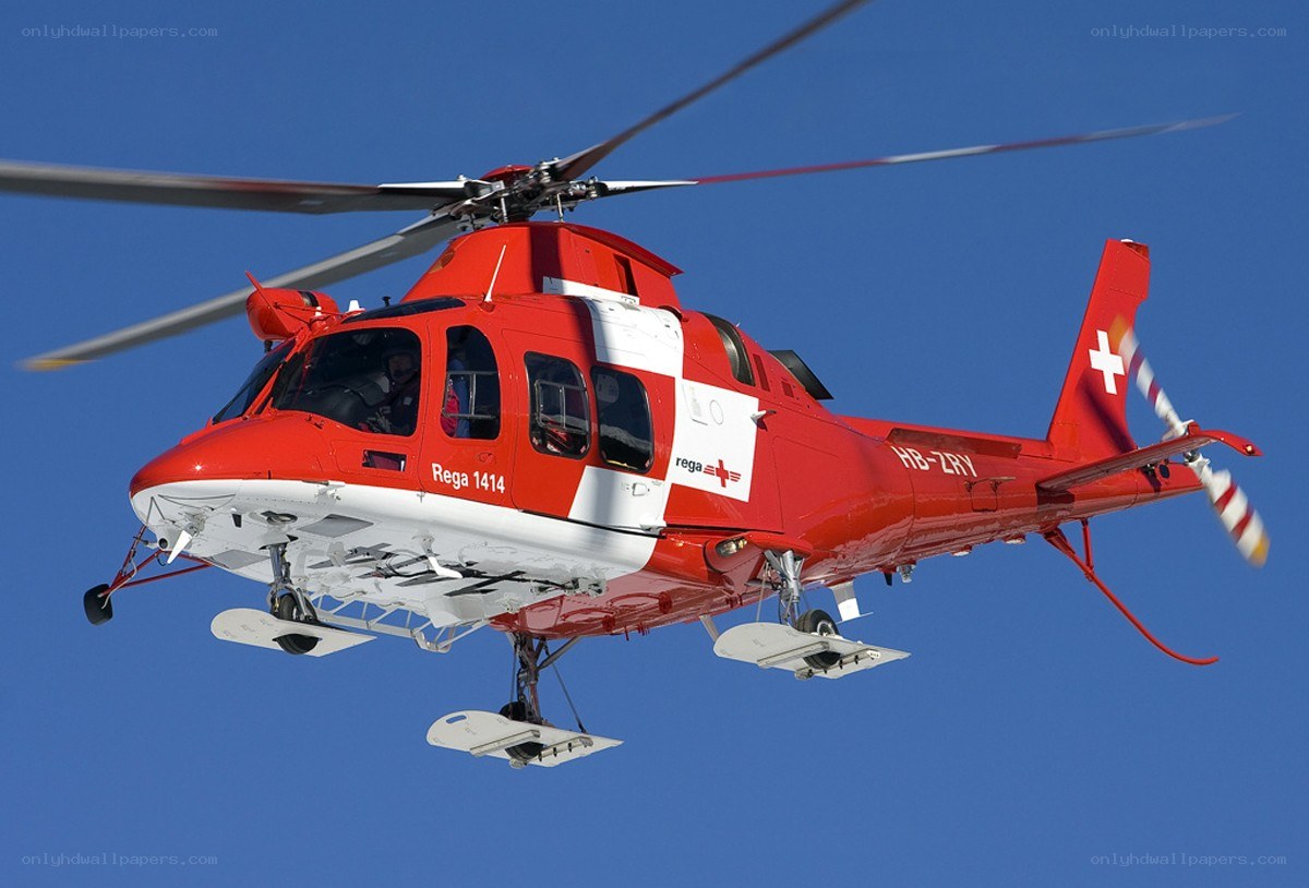 Red rescue helicopter in flight
