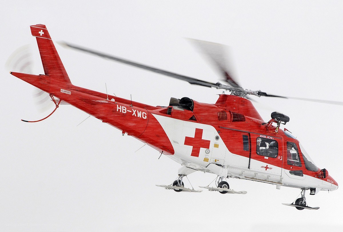 Red rescue helicopter in flight