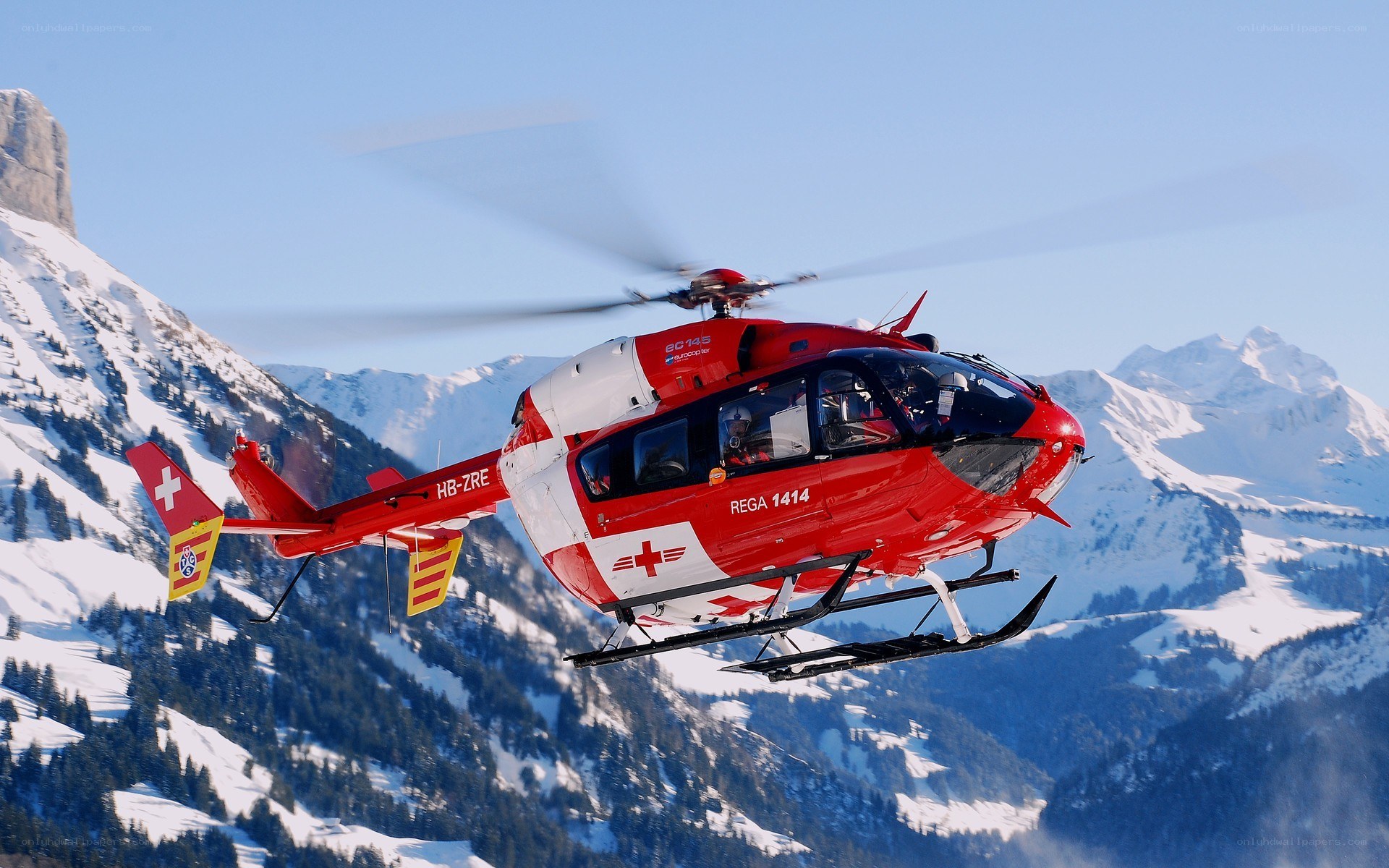 Red rescue helicopter in mountains