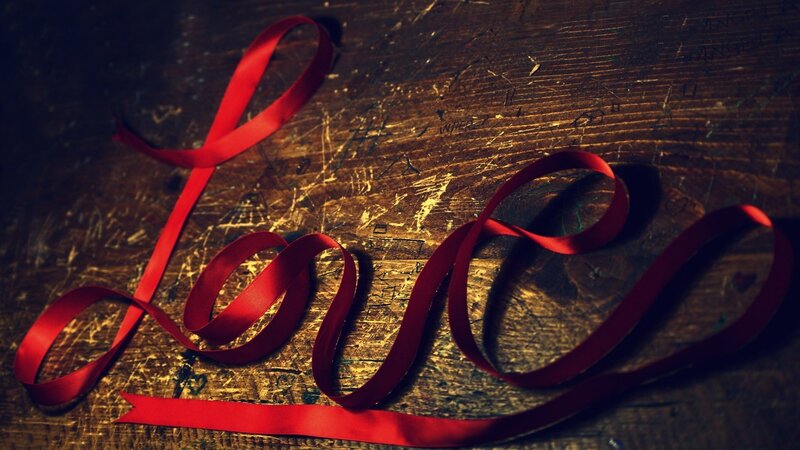 Red ribbon spelling love