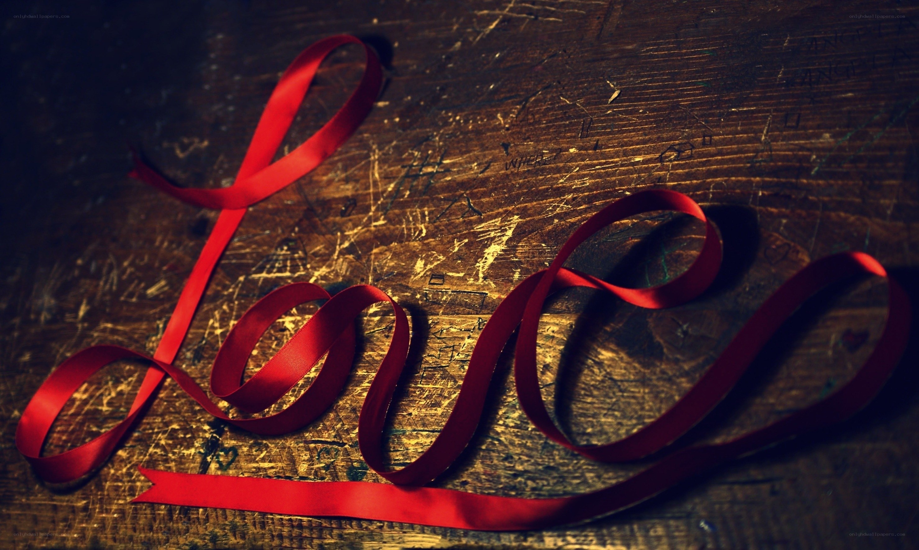 Red ribbon spelling love