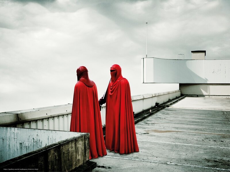 Red-robed figures on a rooftop
