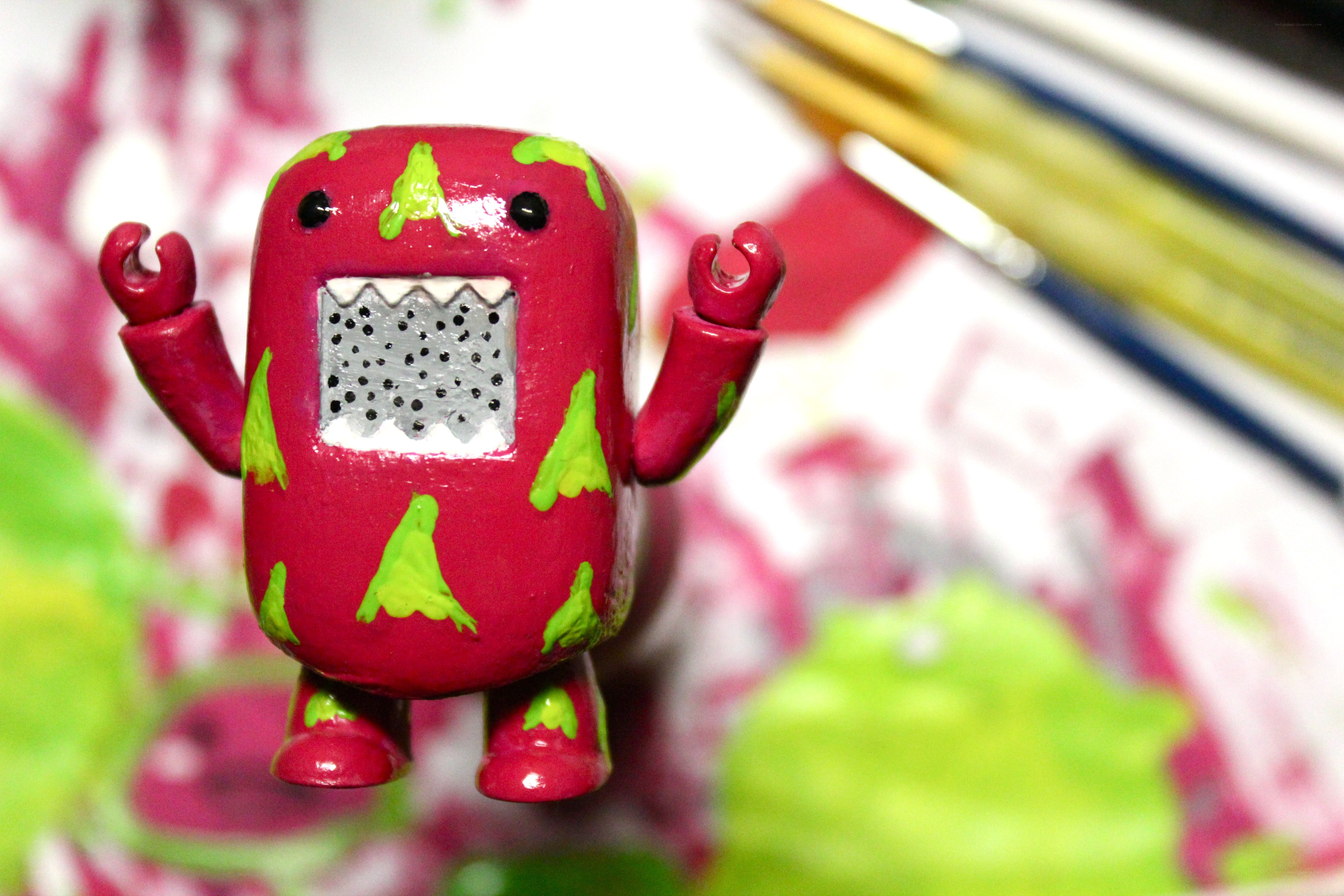 Red robot figurine with green spots
