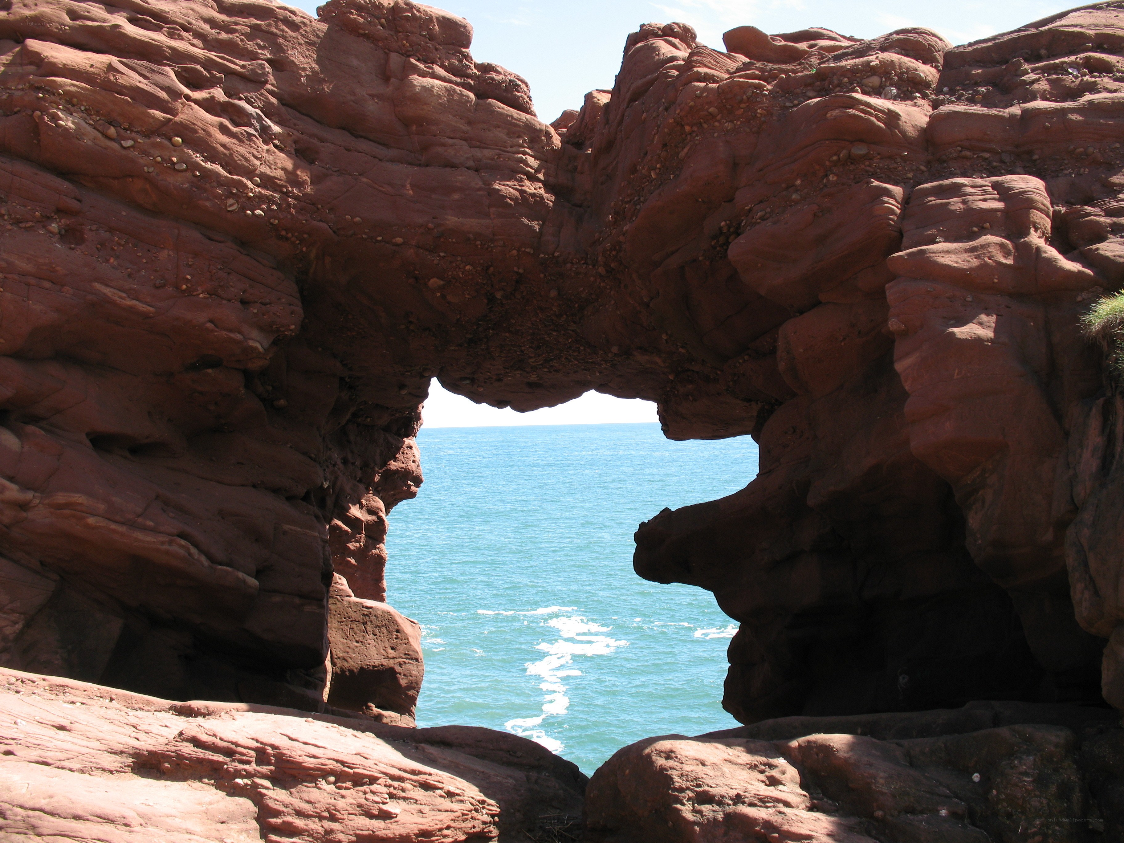 Red rock arch overlooking the sea