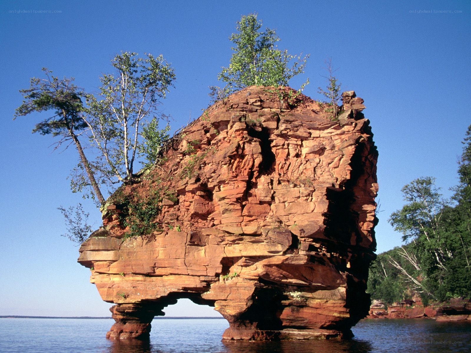 Red rock formation in lake