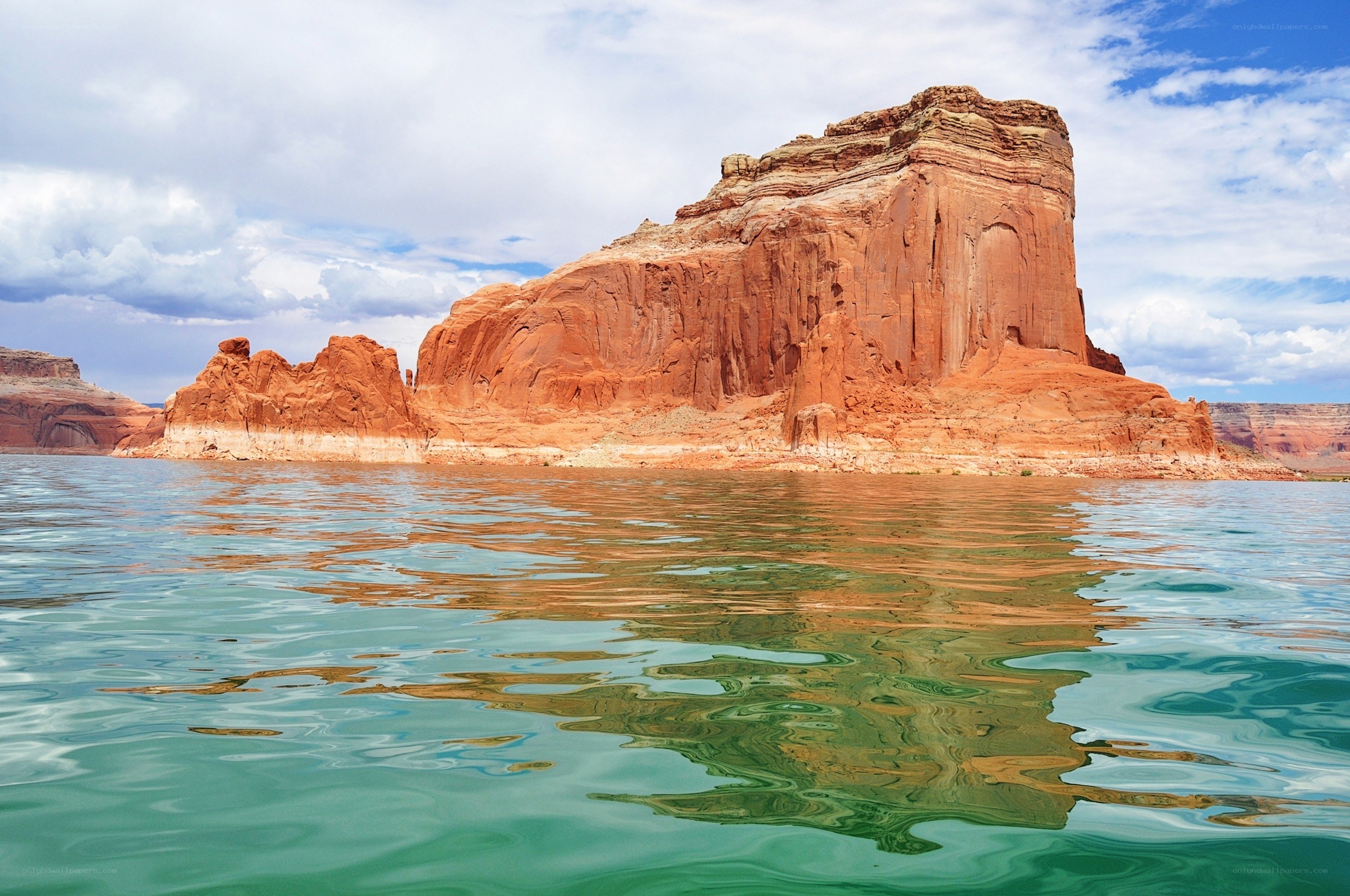 Red rock formation in lake