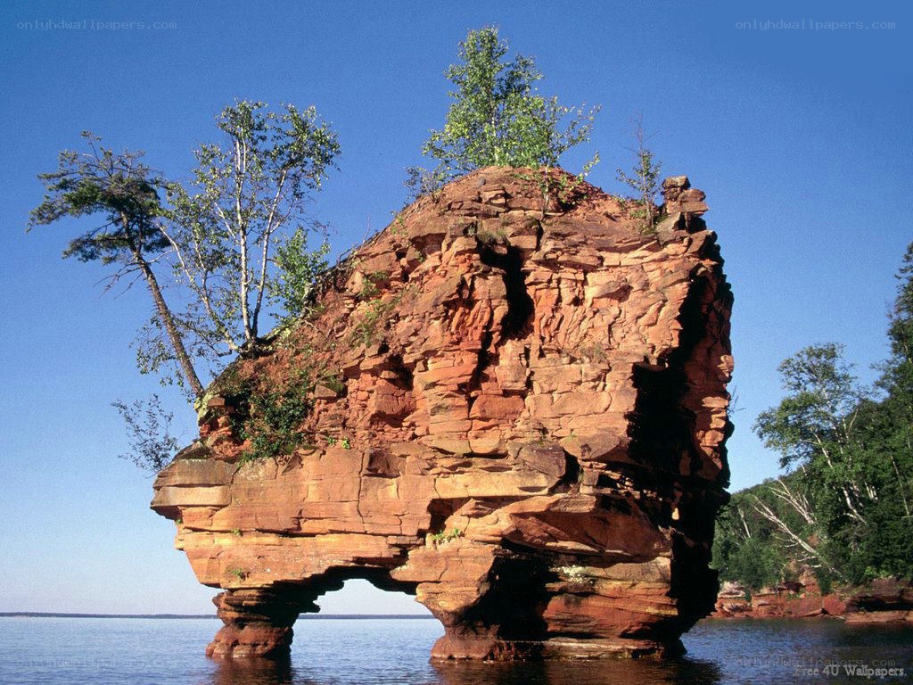 Red rock formation in lake