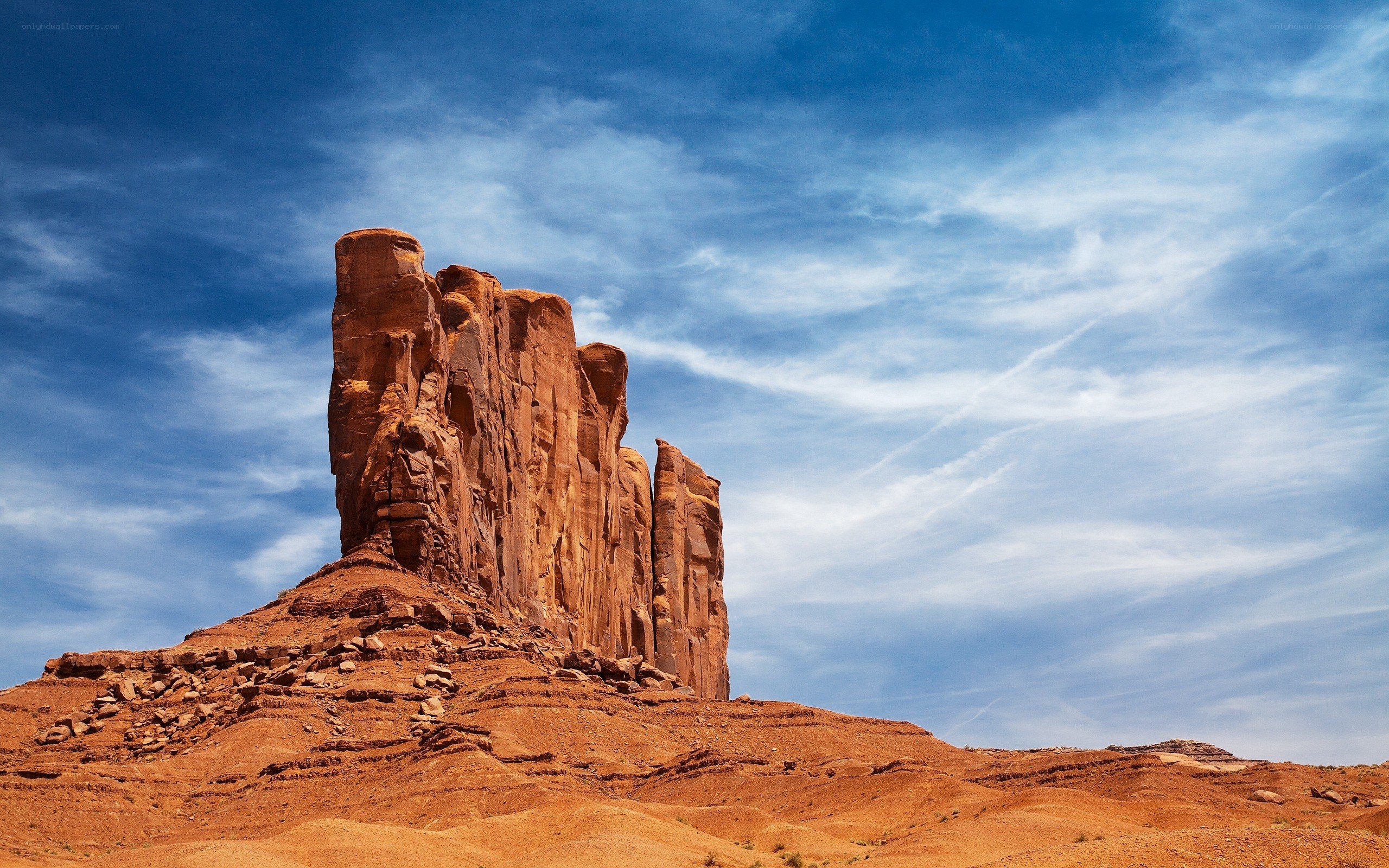 Red rock formation under blue sky