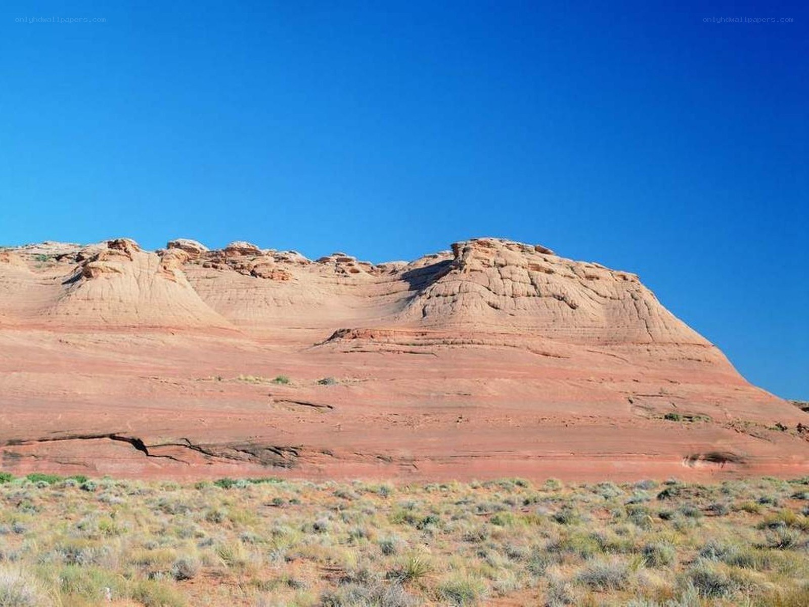 Red rock formation under blue sky