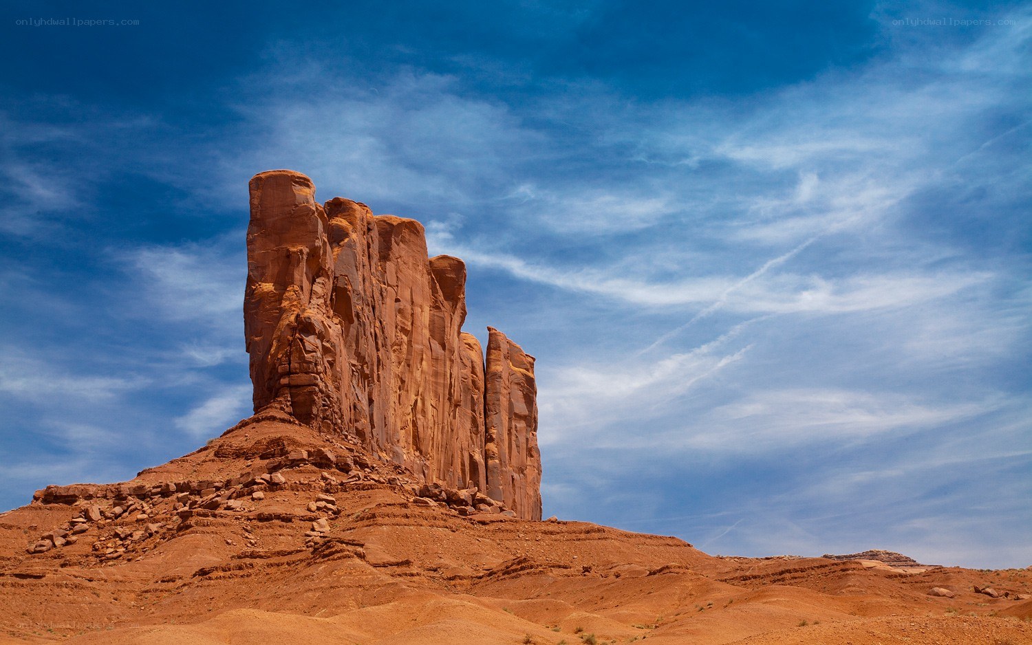 Red rock formation under blue sky