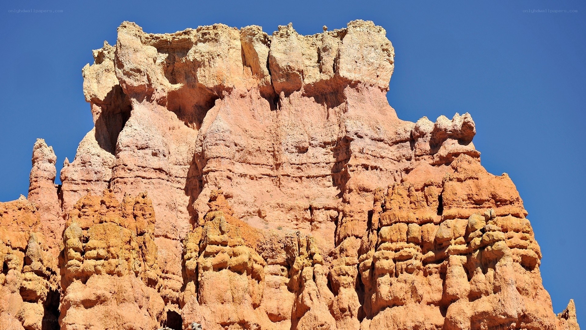 Red rock formation under blue sky