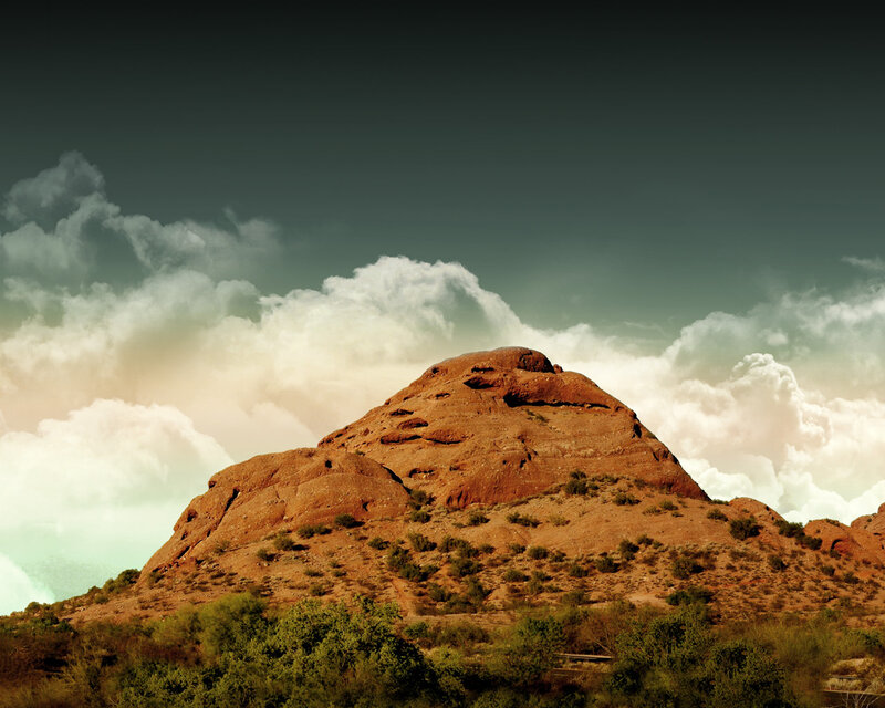 Red rock formation under cloudy sky