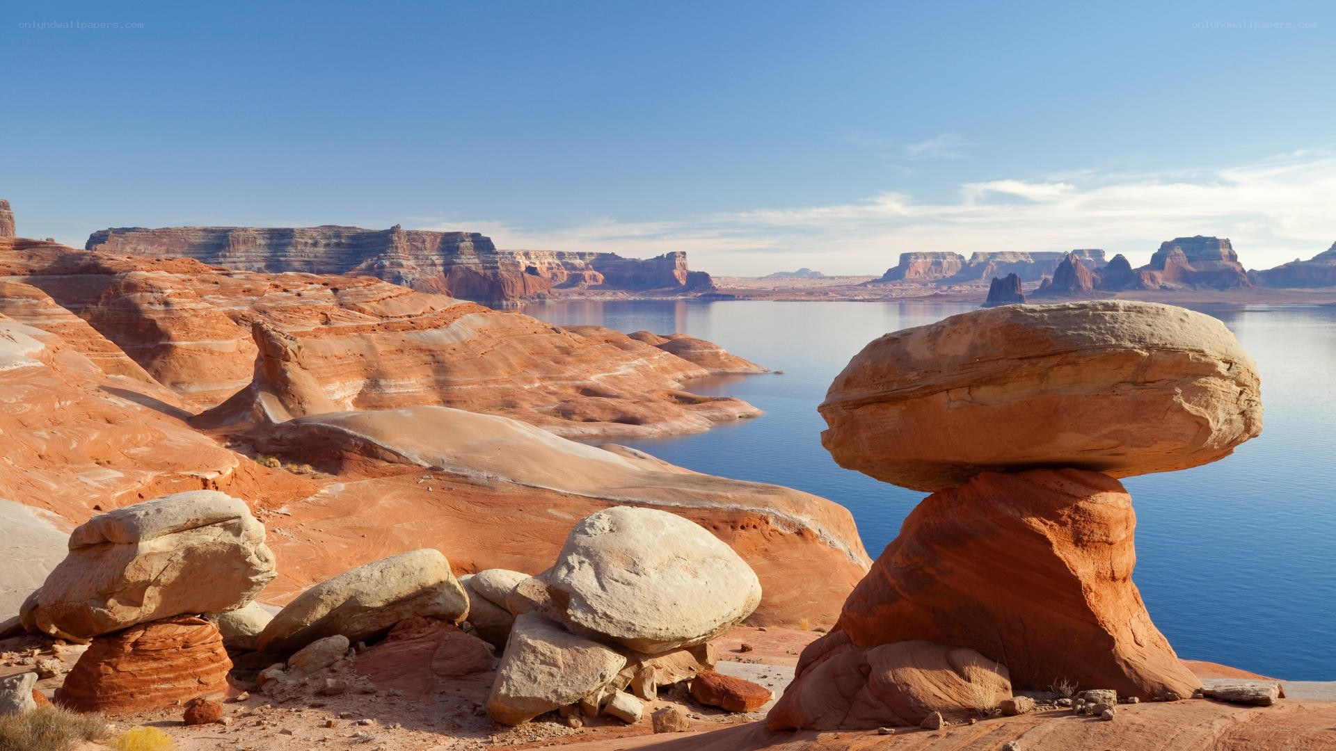 Red rock formations by lake