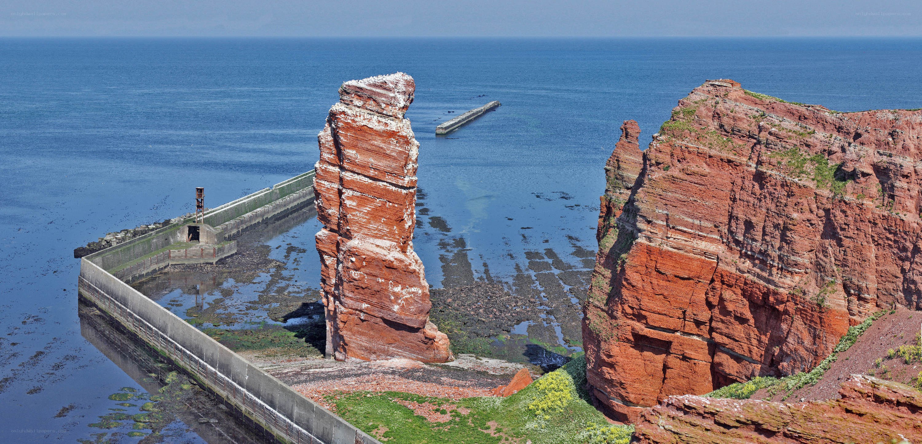 Red rock formations by the sea
