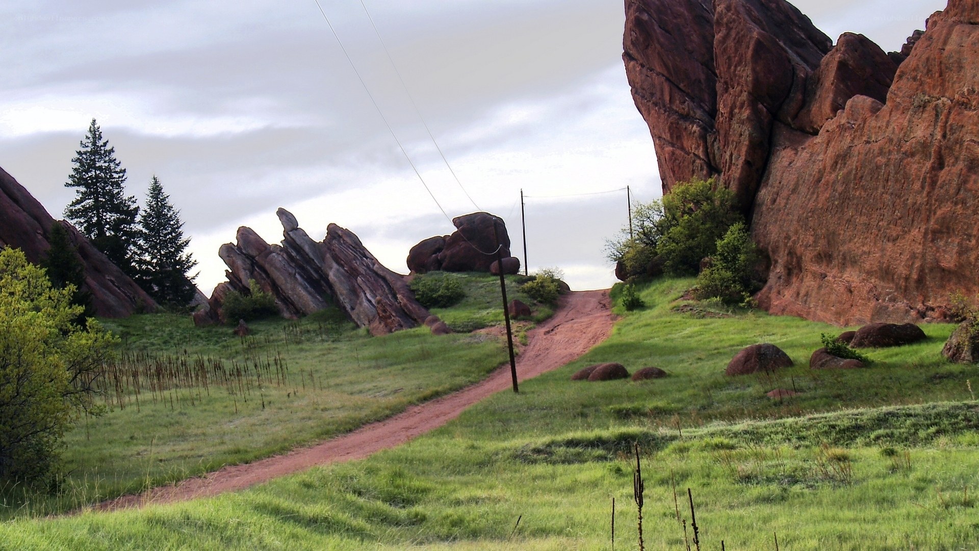Red rock formations in a grassy valley