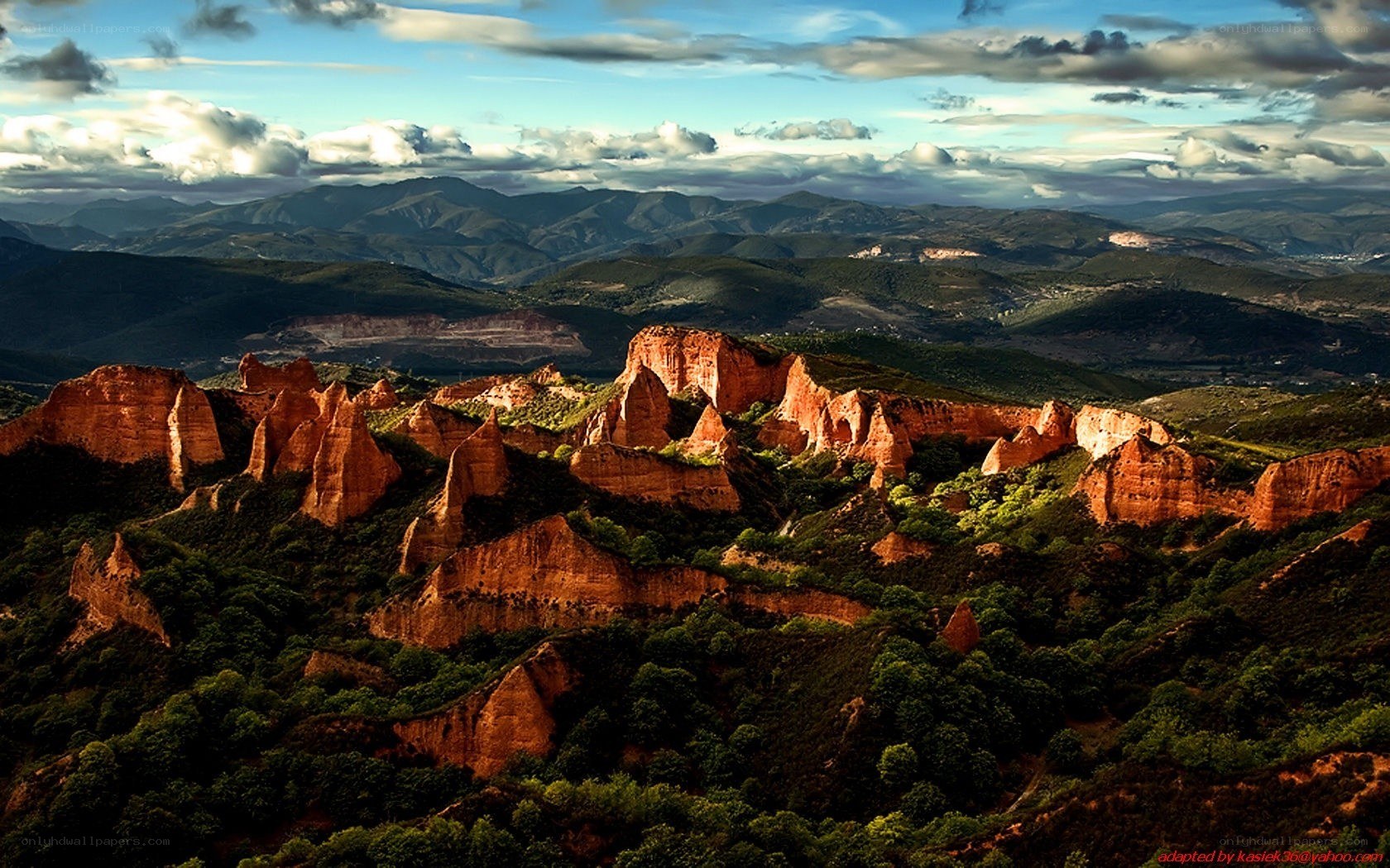 Red rock formations in mountain landscape