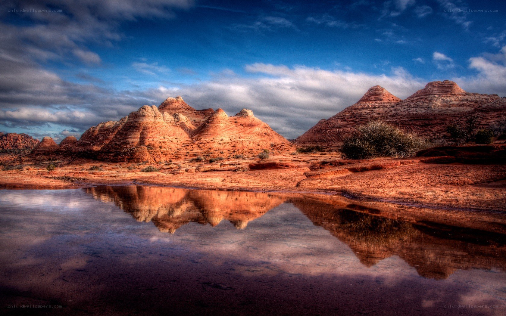 Red rock formations reflected in water