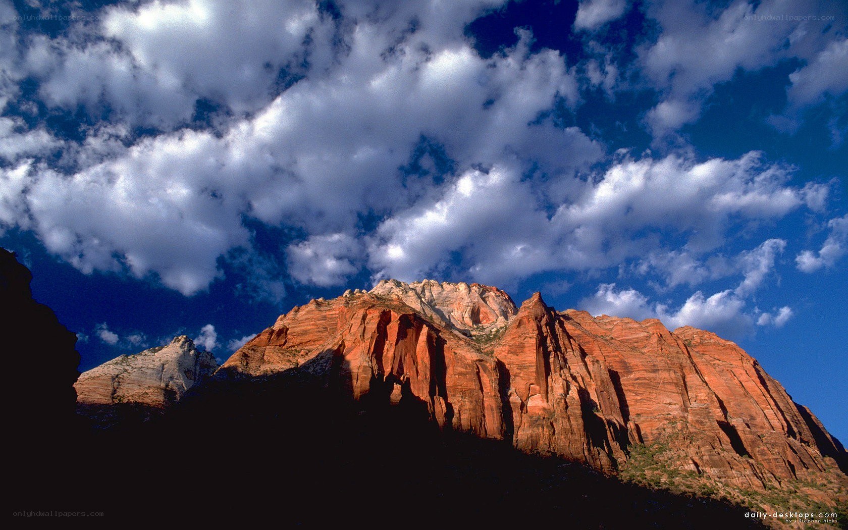 Red rock formations under cloudy sky