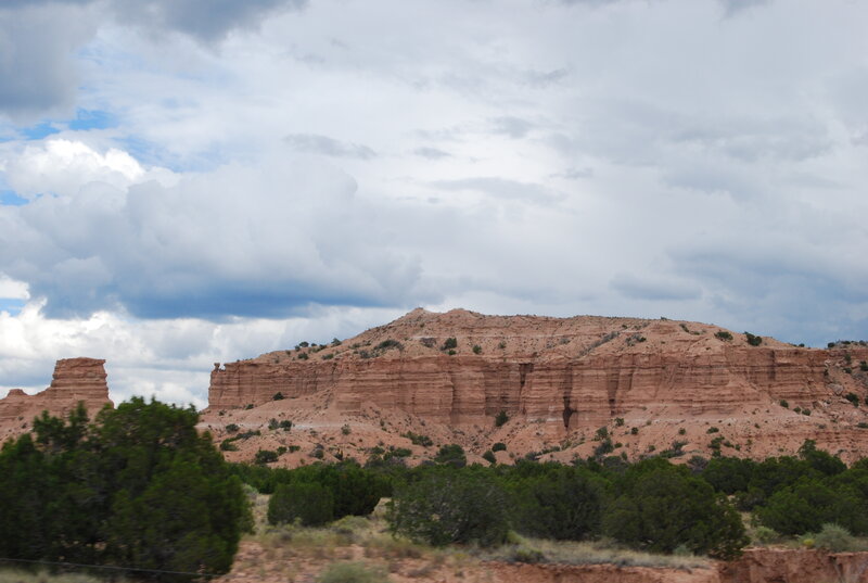 red rock formations under cloudy sky