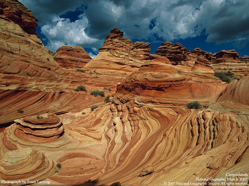 Red rock formations under stormy sky