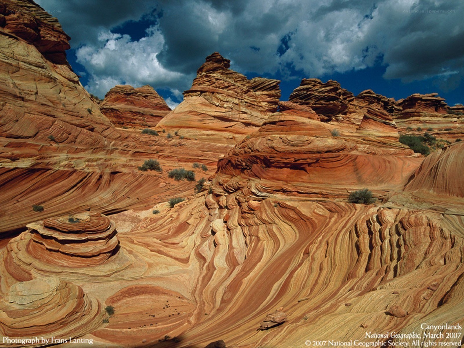 Red rock formations under stormy sky