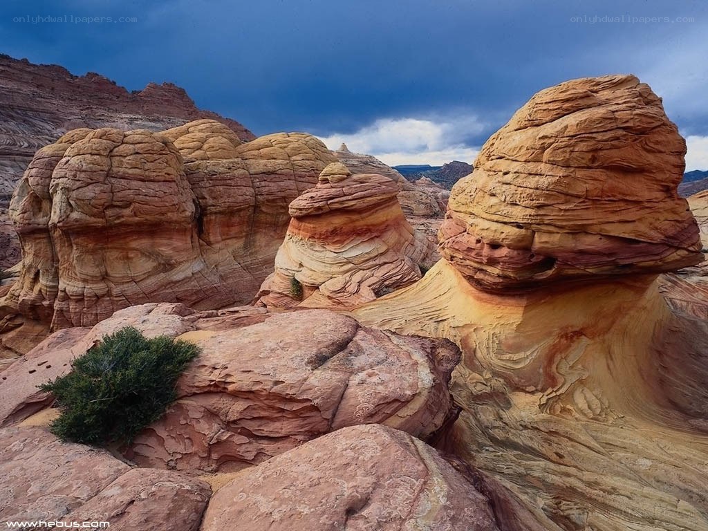 Red rock formations under stormy sky