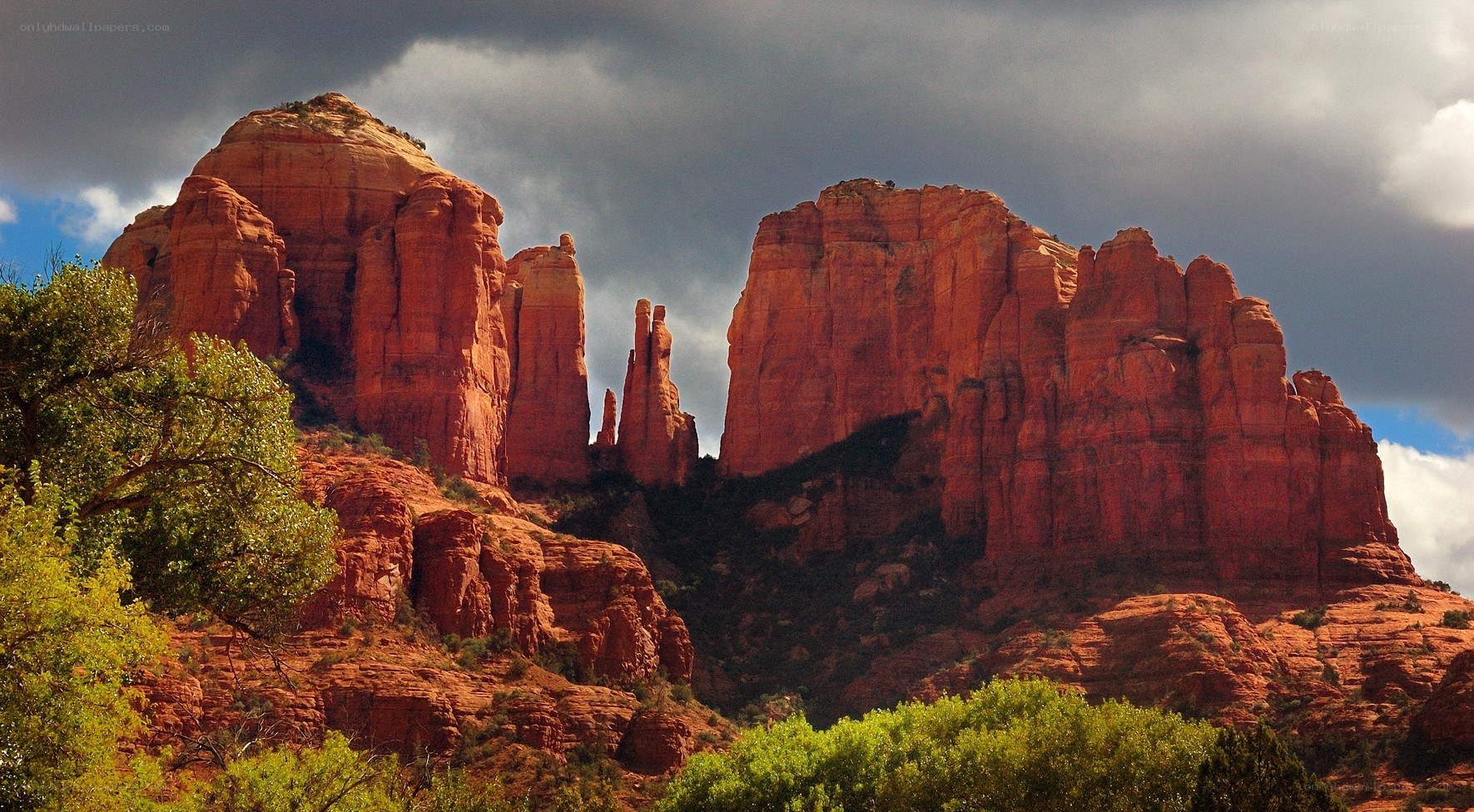 Red rock formations under stormy sky