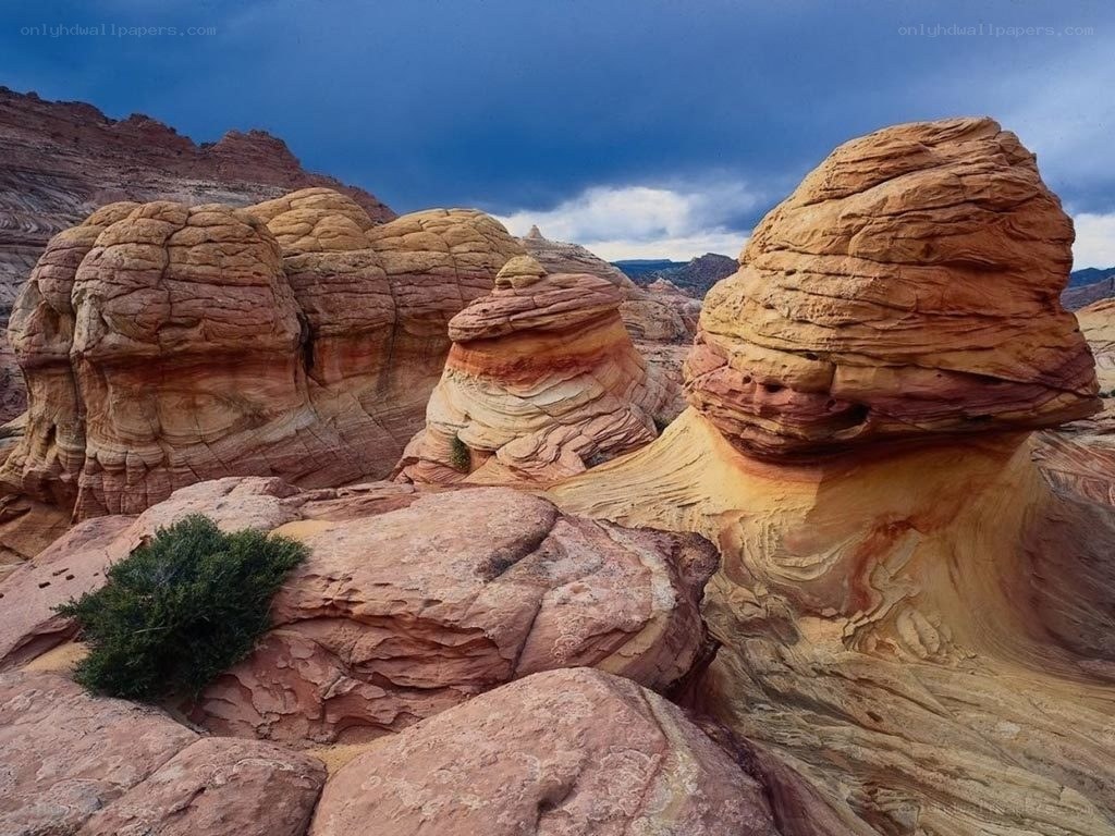 Red rock formations under stormy sky
