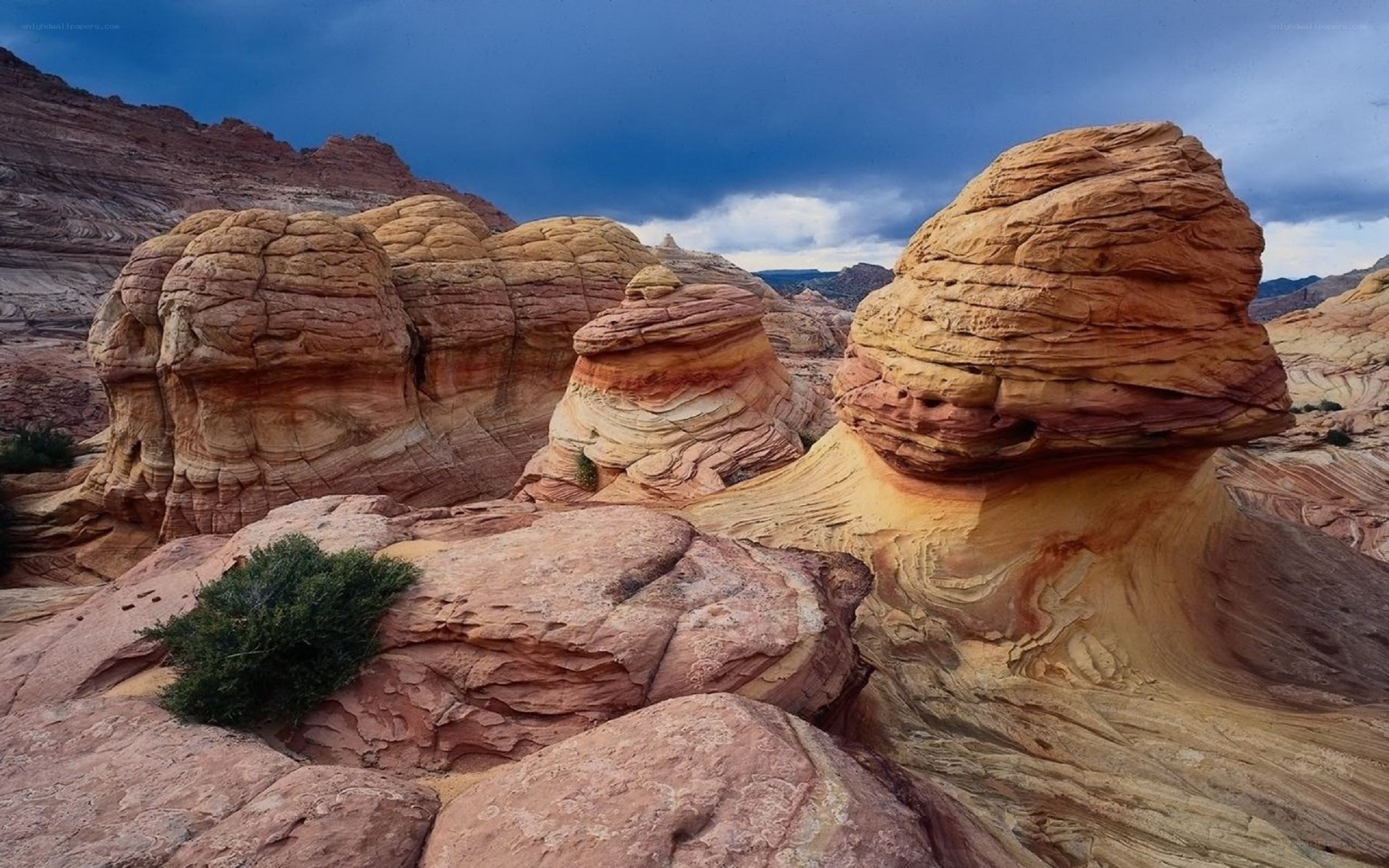 Red rock formations under stormy sky
