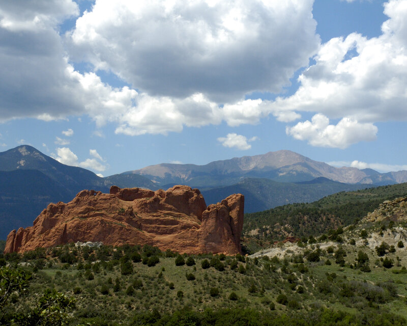 Red rock formations with mountains